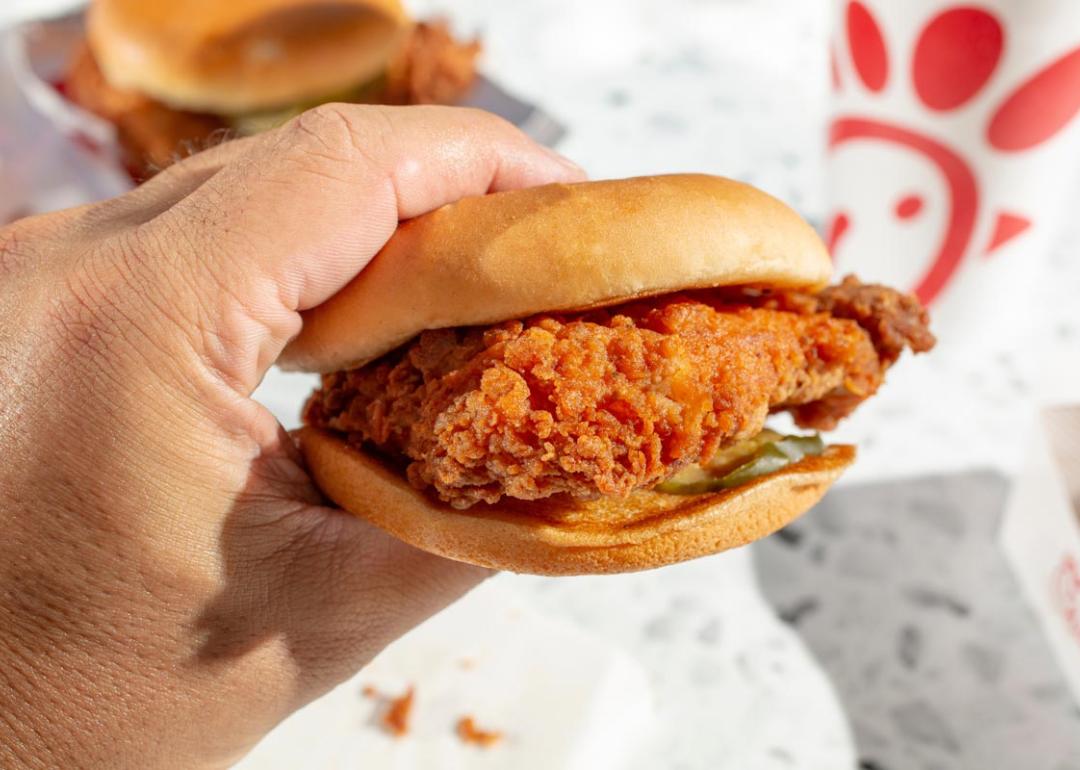 A view of a hand holding a Chick-Fil-A chicken sandwich.