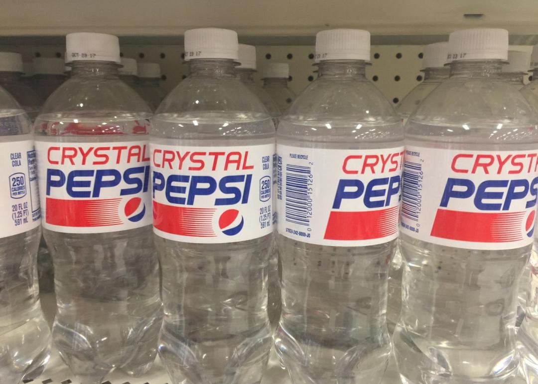 Crystal Pepsi plastic soda bottles on the store shelves for sale.