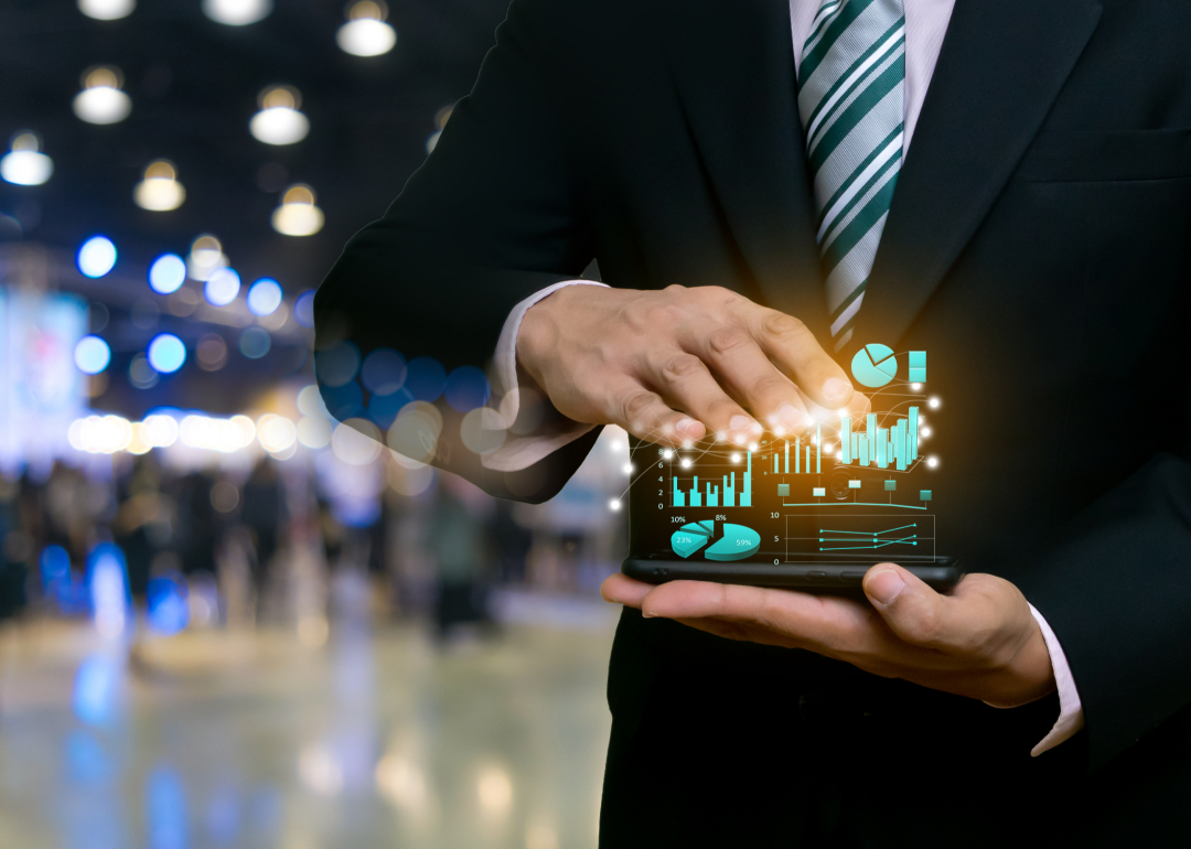 A man displaying investment charts on a tablet