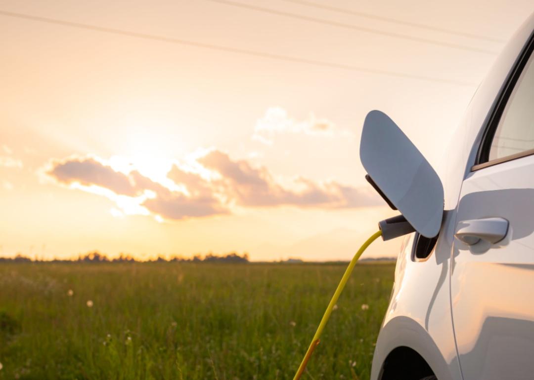A charging vehicle with a sunset in the background.