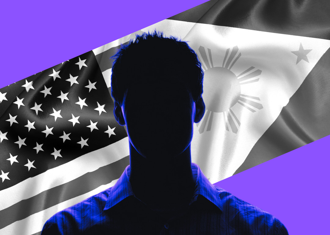 A silhouette of a man in front of an American flag and a Philippines flag.