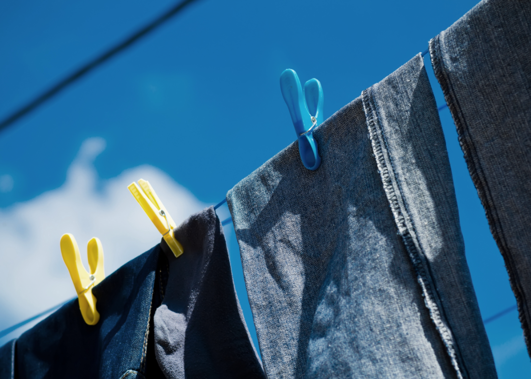 Blue jeans hanging on an outdoor clothes line.