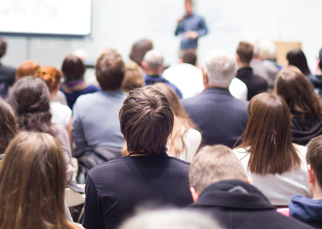 Rear view of students listening in a lecture hall