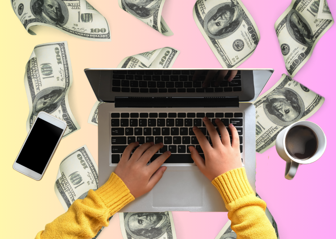 Illustration of hands on a laptop with hundred dollar bills floating in the background.