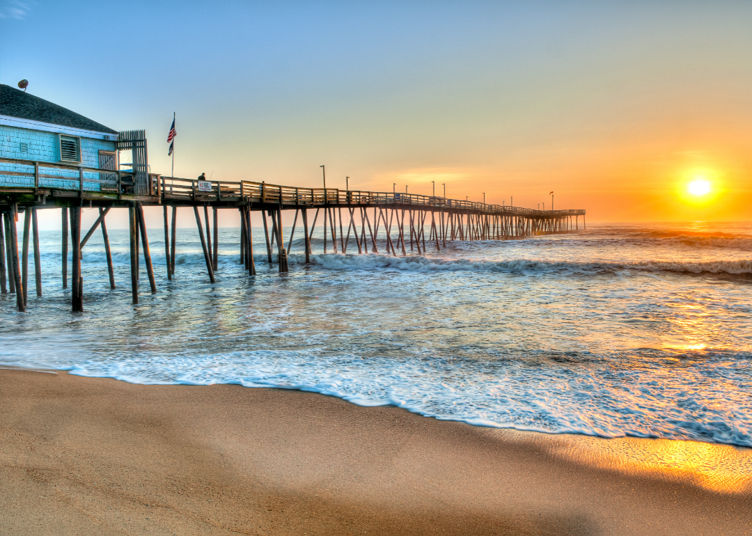A pier in the Outer Banks of North Carolina at sunrise.