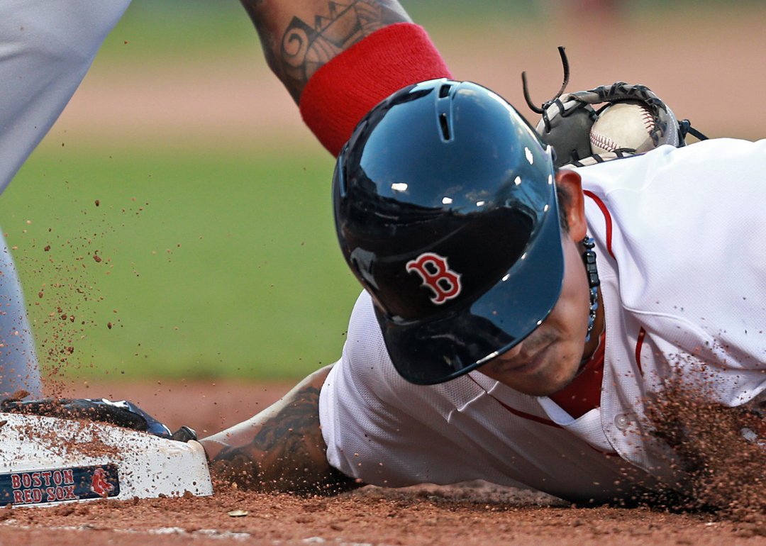 A Red Sox player is tagged out at first base