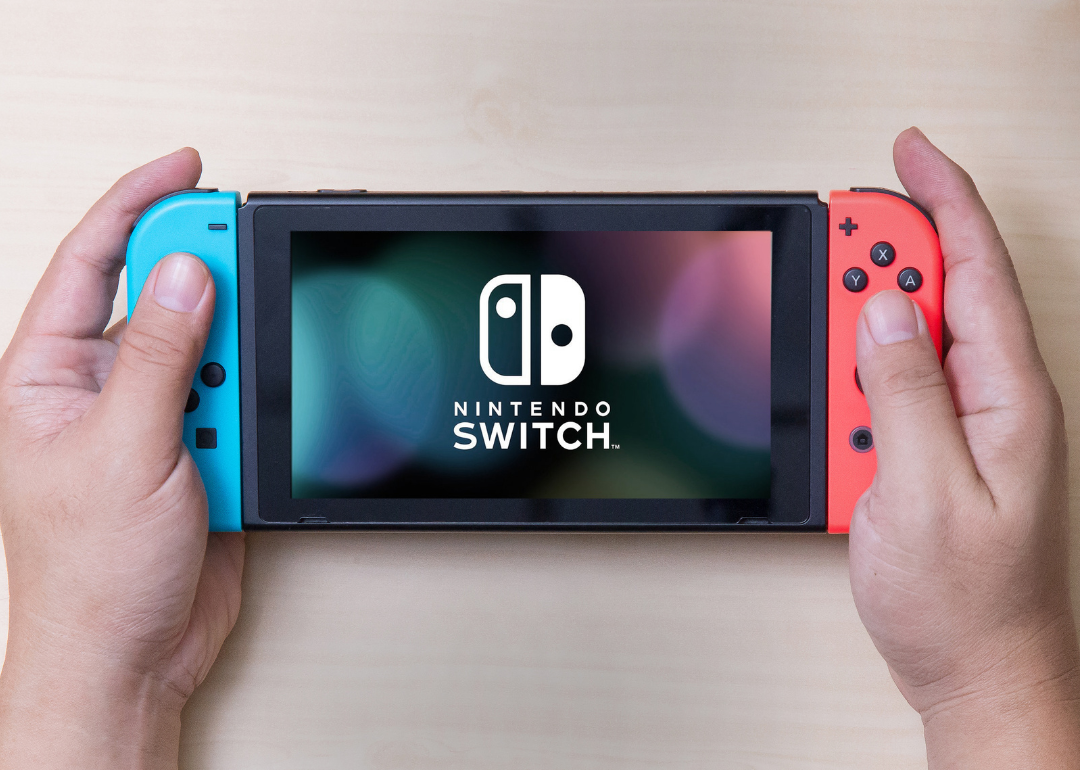 A person's hands holding a Nintendo Switch.