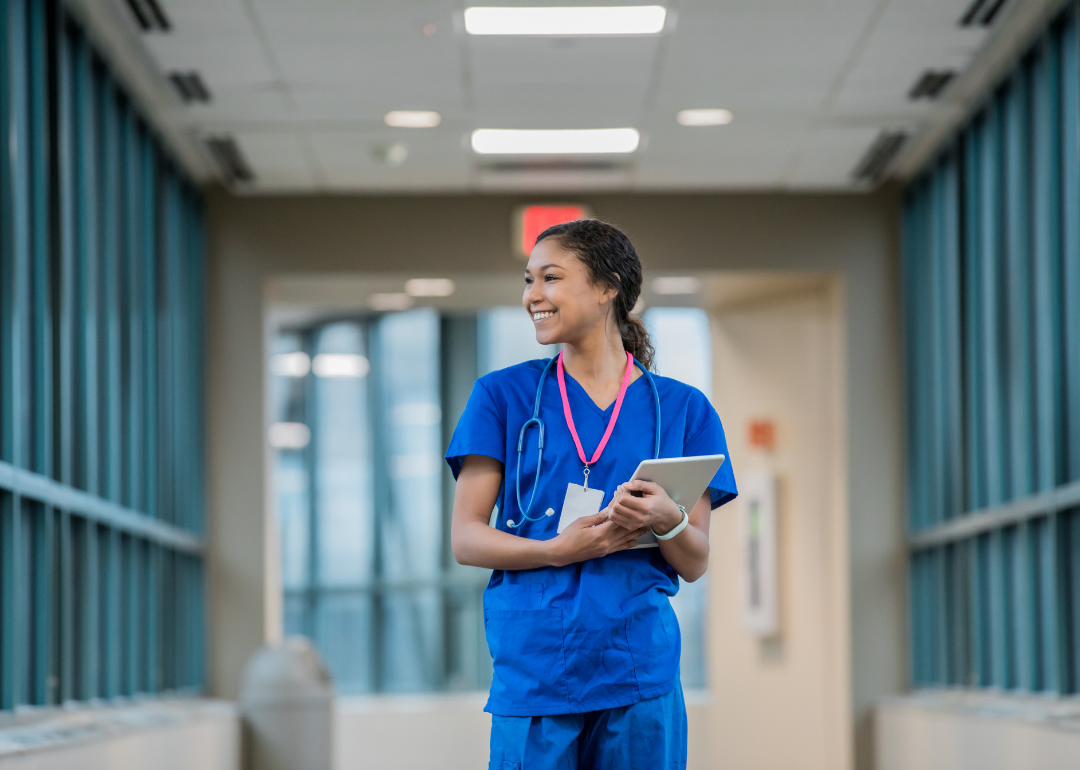 A registered nurse walking down a hallway