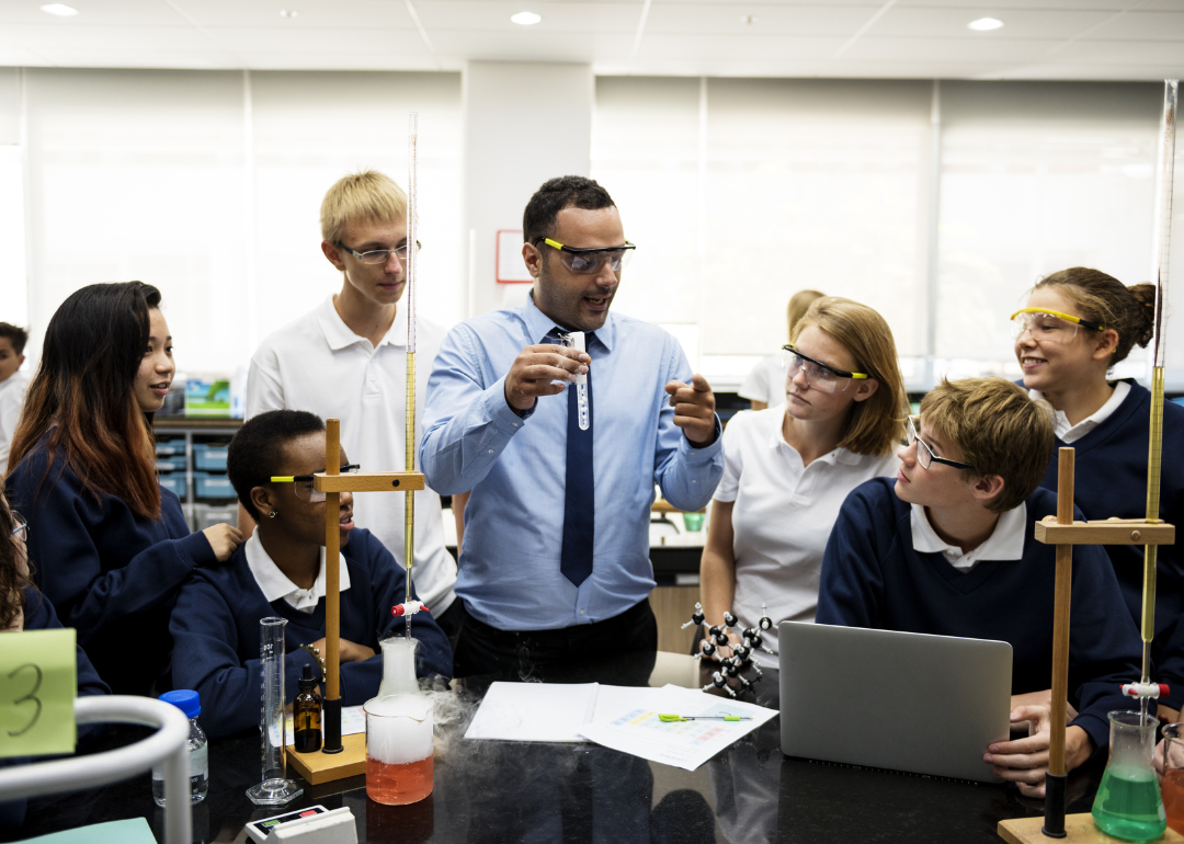 A teacher completing a demonstration for students in a science lab