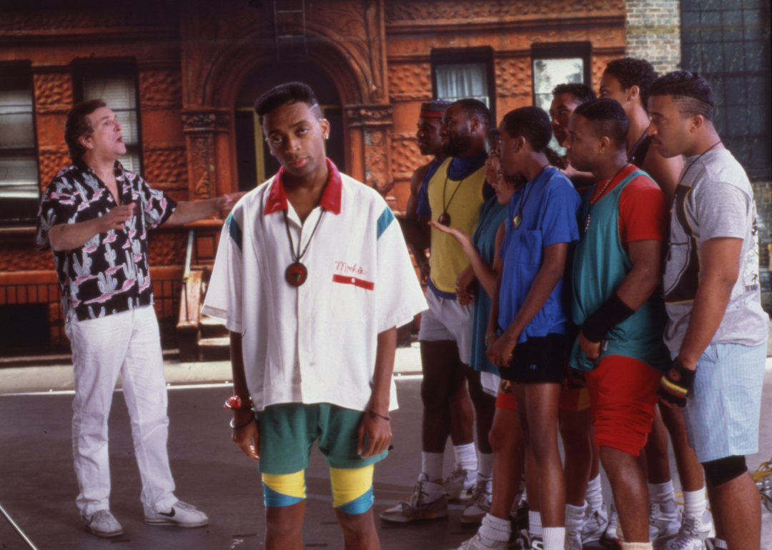 American film director and actor Spike Lee (center) speaking to actors on the set of his film 'Do the Right Thing,' with Danny Aiello in the foreground.