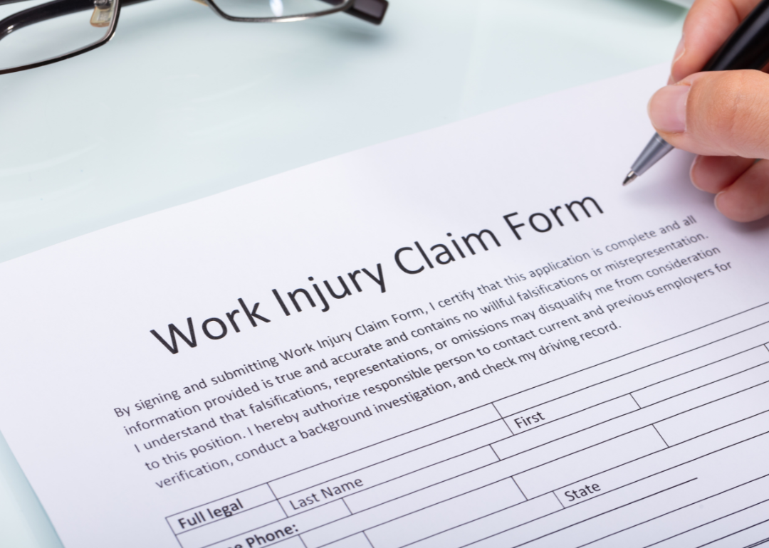 A person completing a work injury claim form