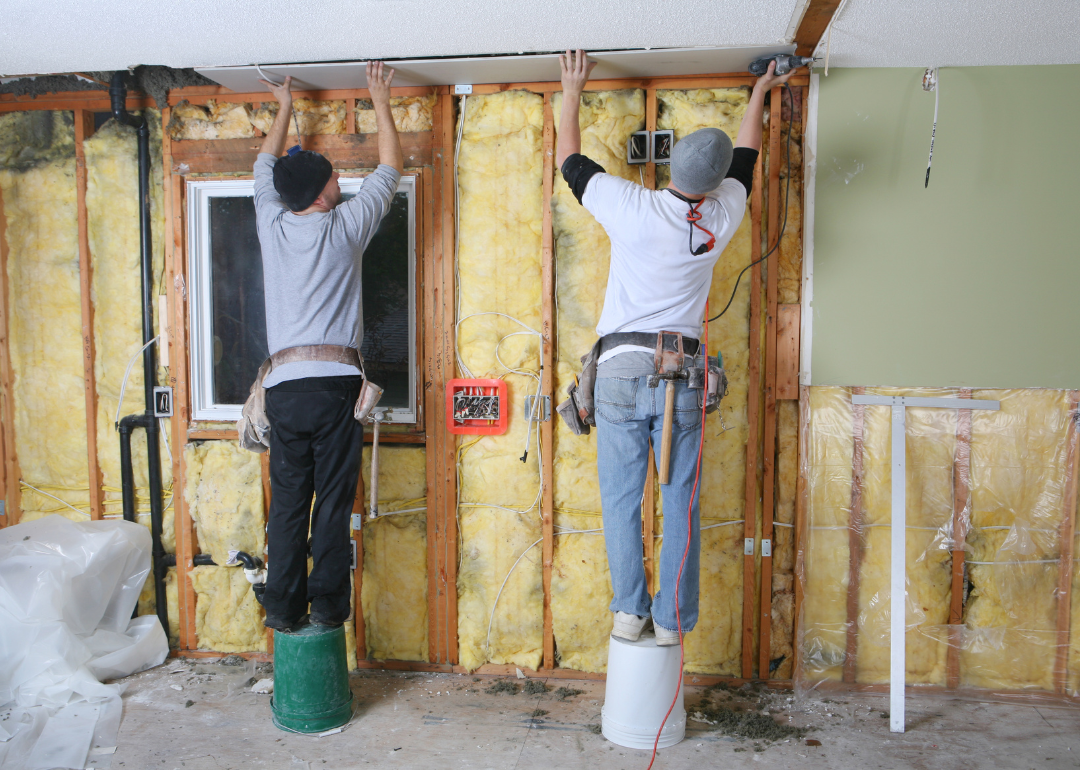 Two men working to remodel a home's walls