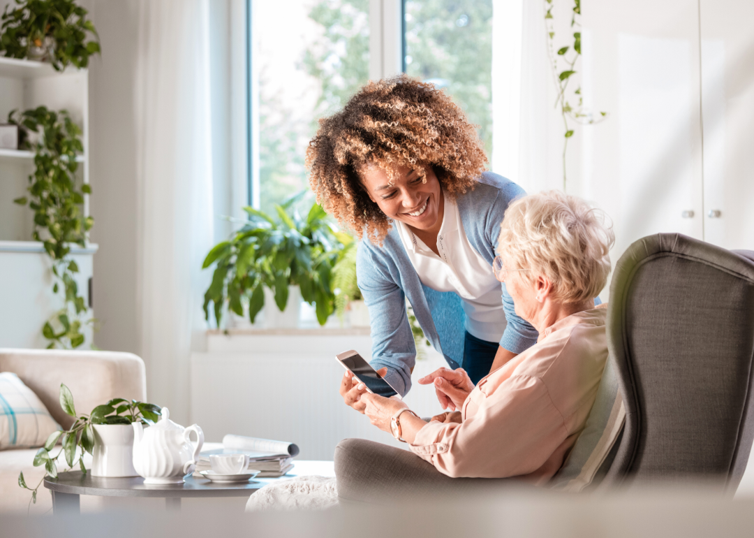 A nurse helping a woman in an assisted living facility.