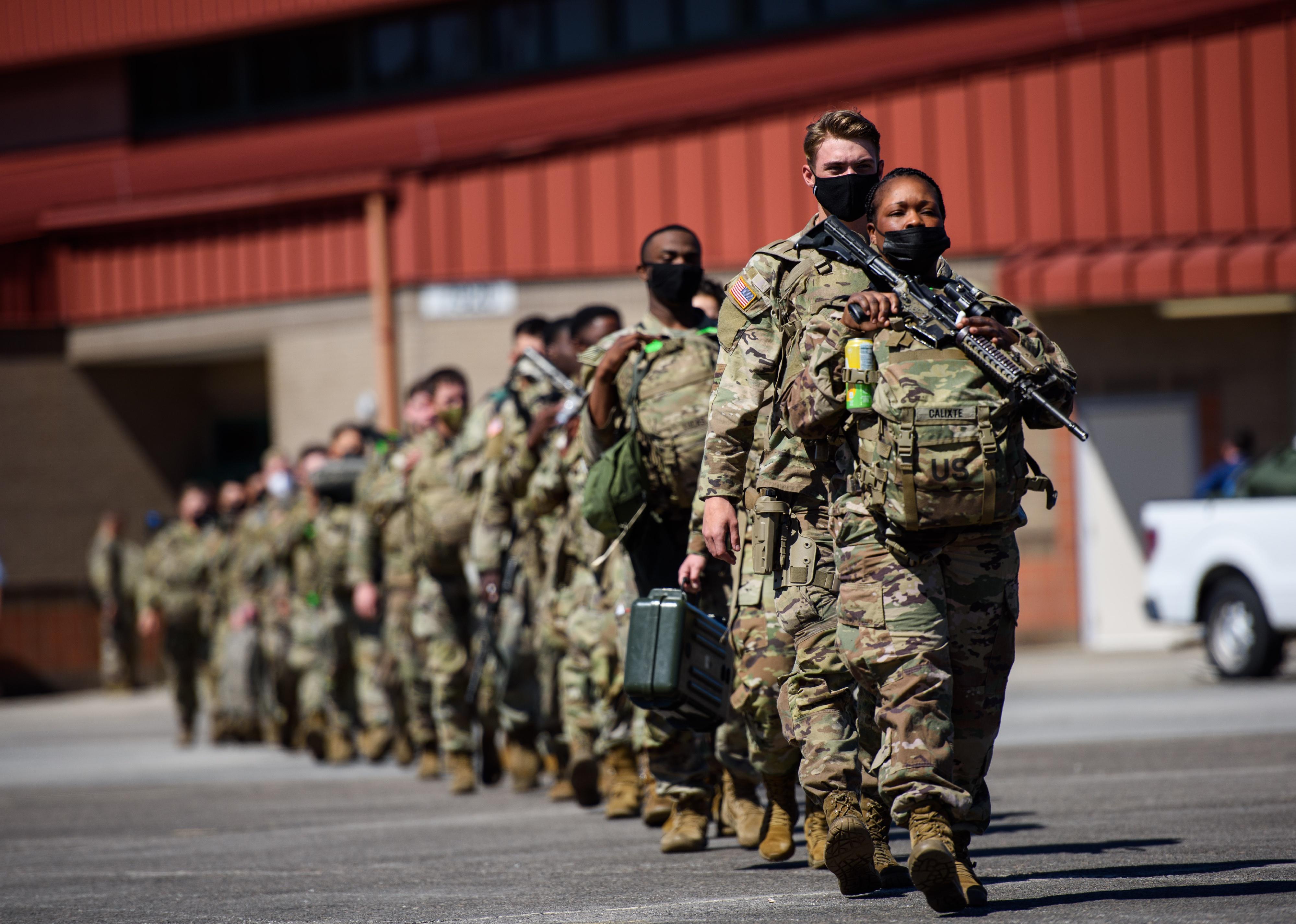 A line of active duty Army soldiers in camouflage.