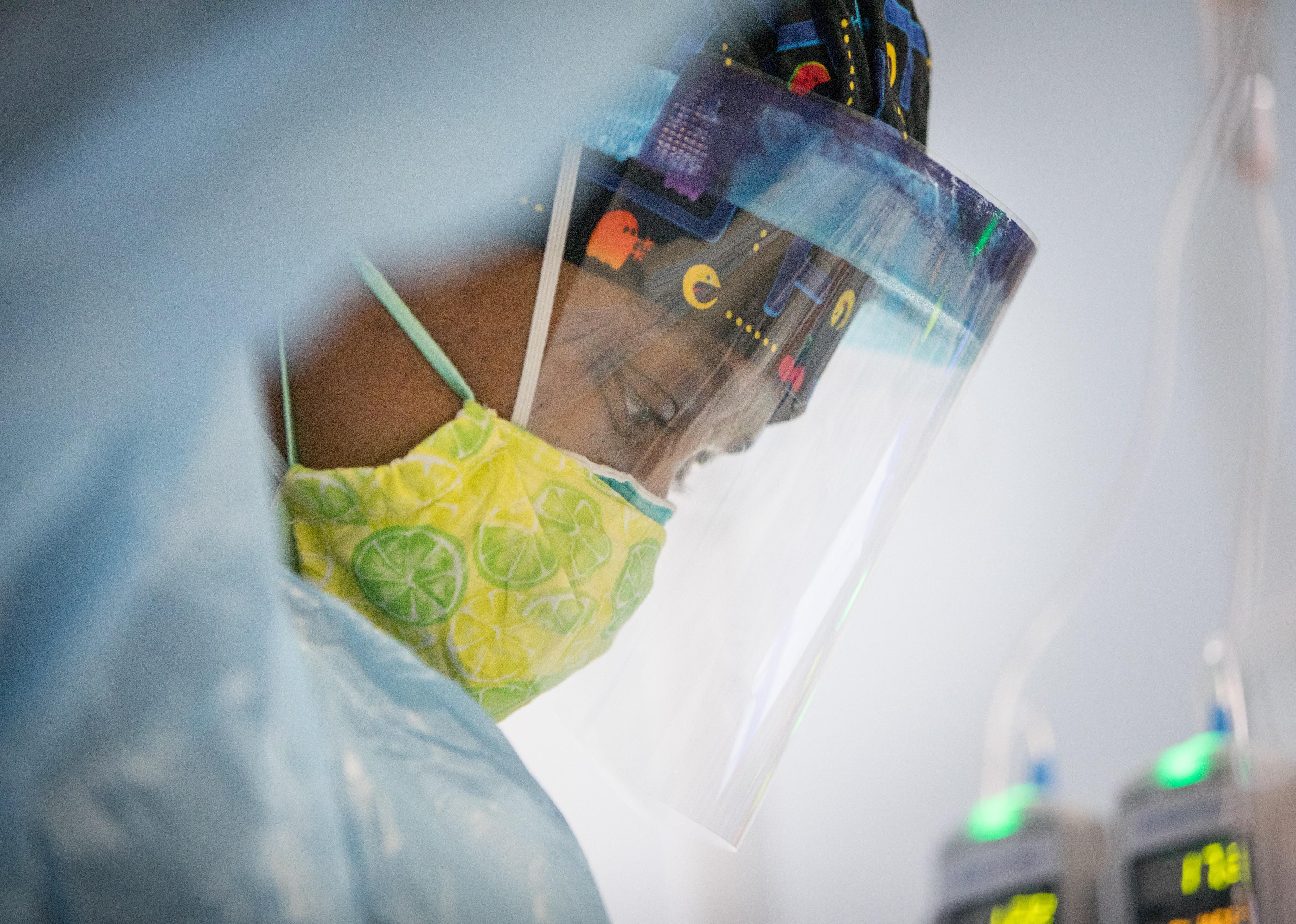 A nurse in a face shield.