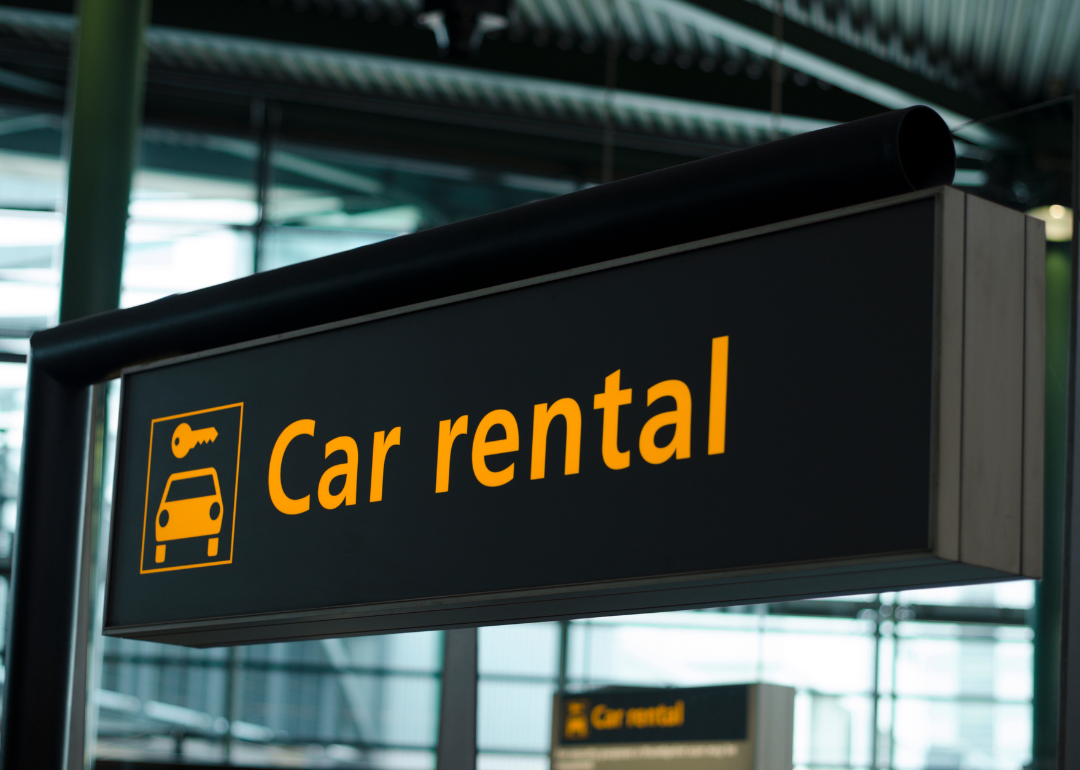 A black and orange car rental sign.