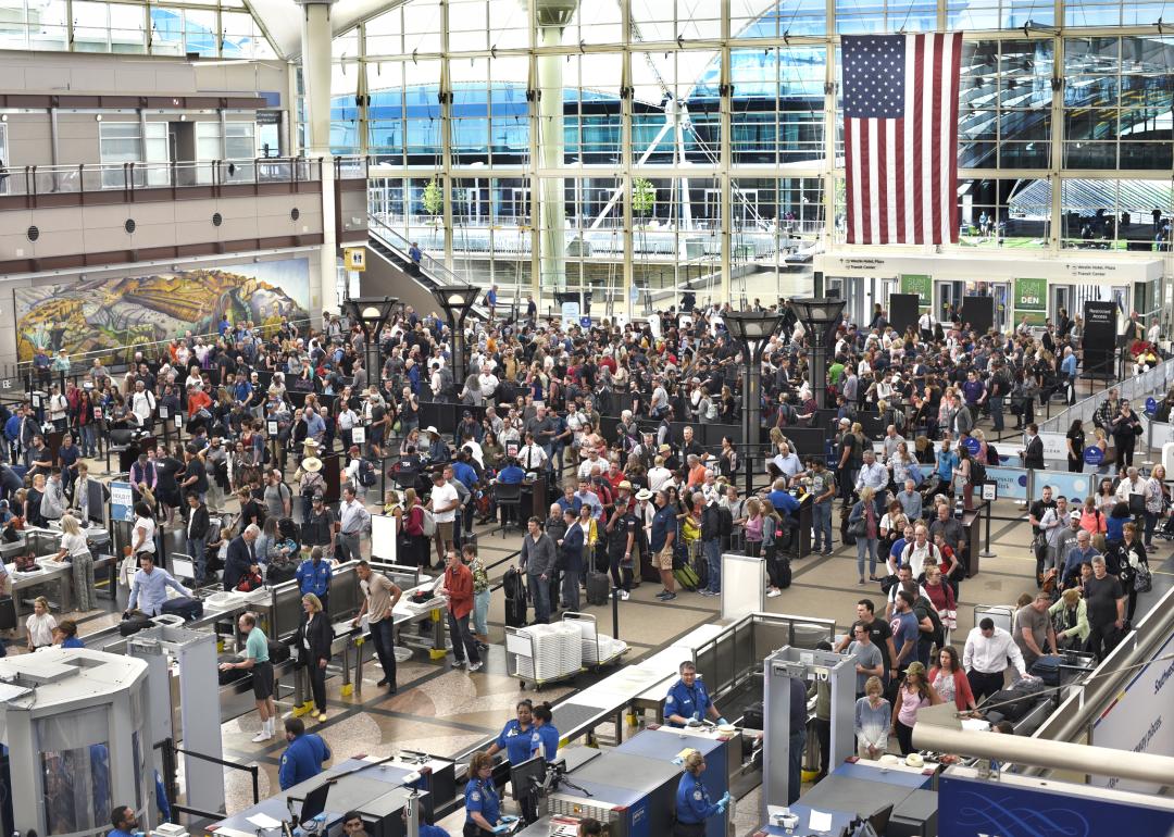 Airplane passengers line up for TSA security screenings at Denver International Airport