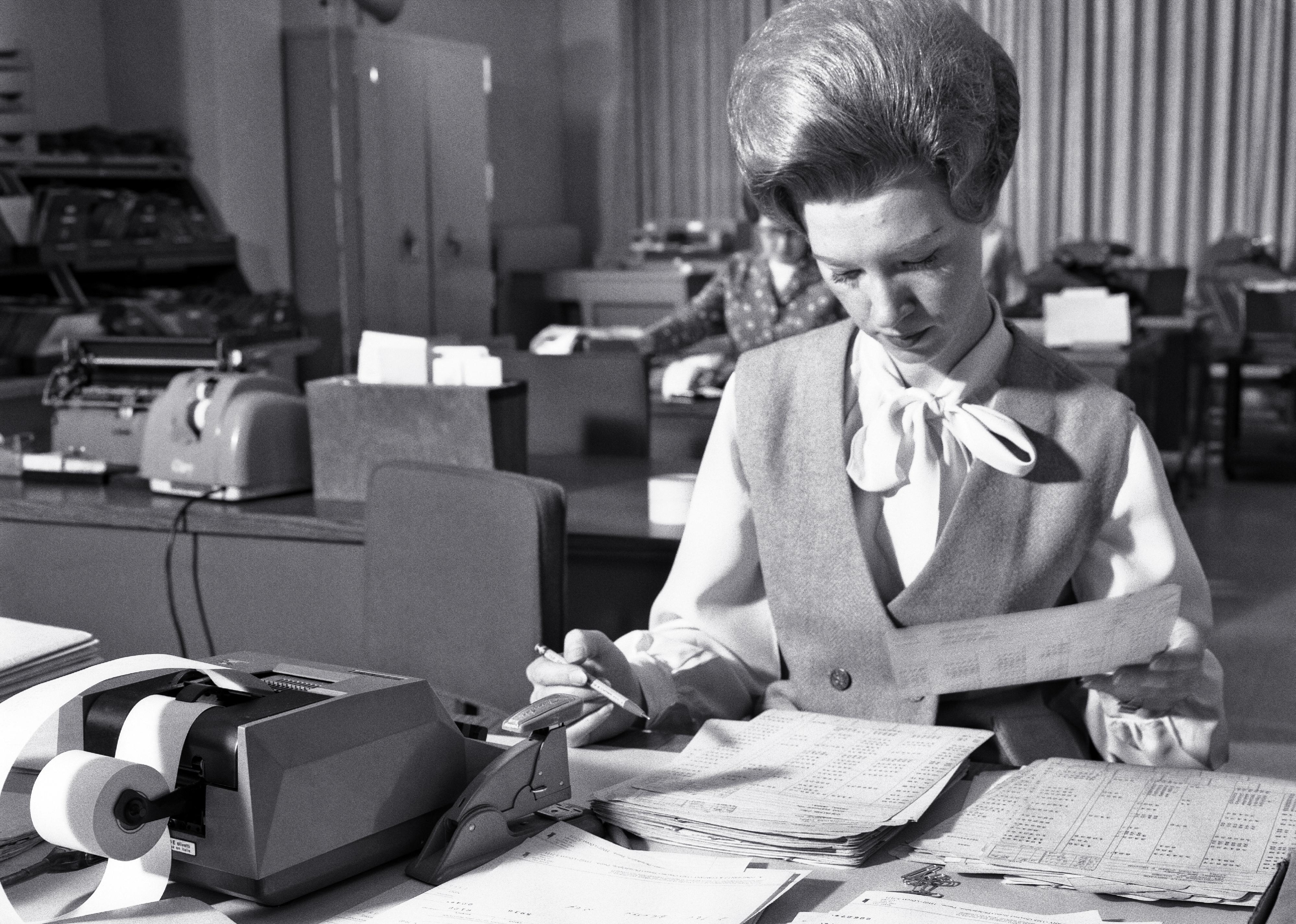 1960s female office worker working at desk