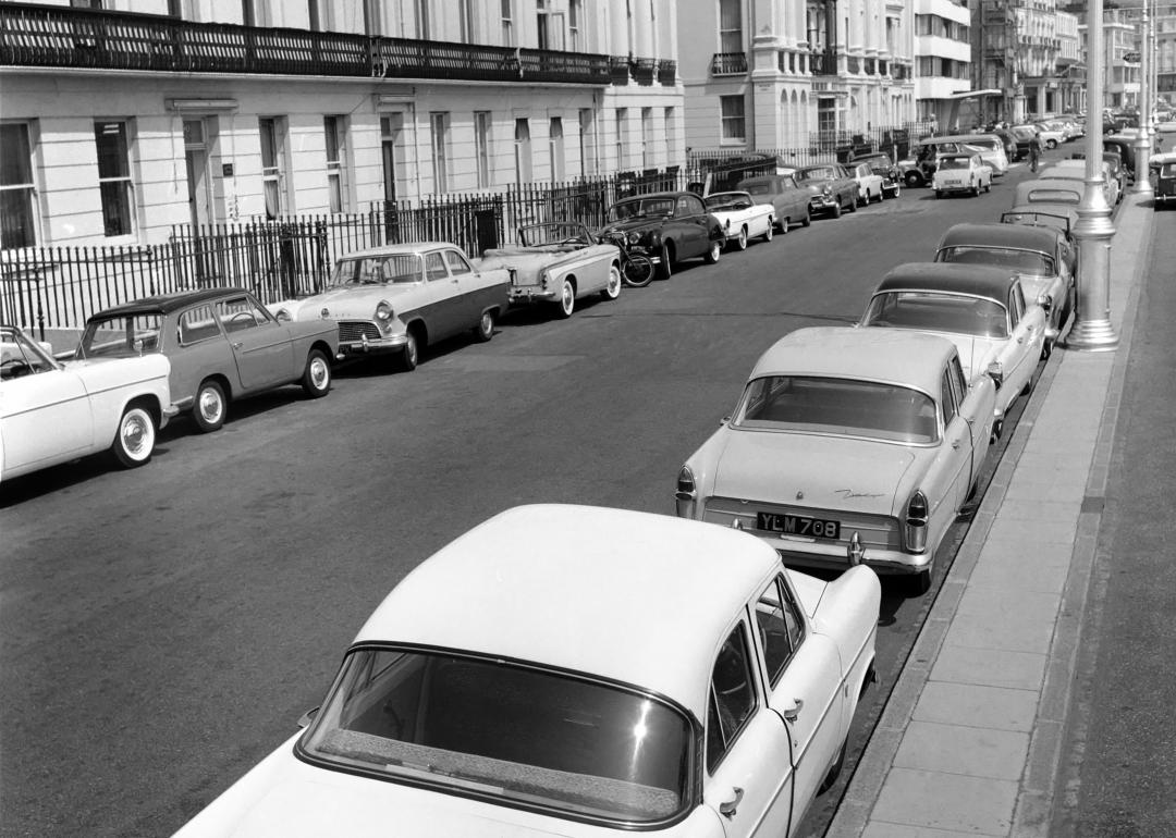 Parked cars on a street, circa June 1960.