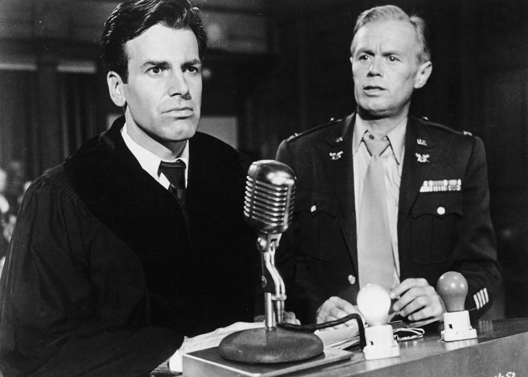 Maximilian Schell and Richard Widmark stand in a courtroom in a still from the film 'Judgment At Nuremberg'.
