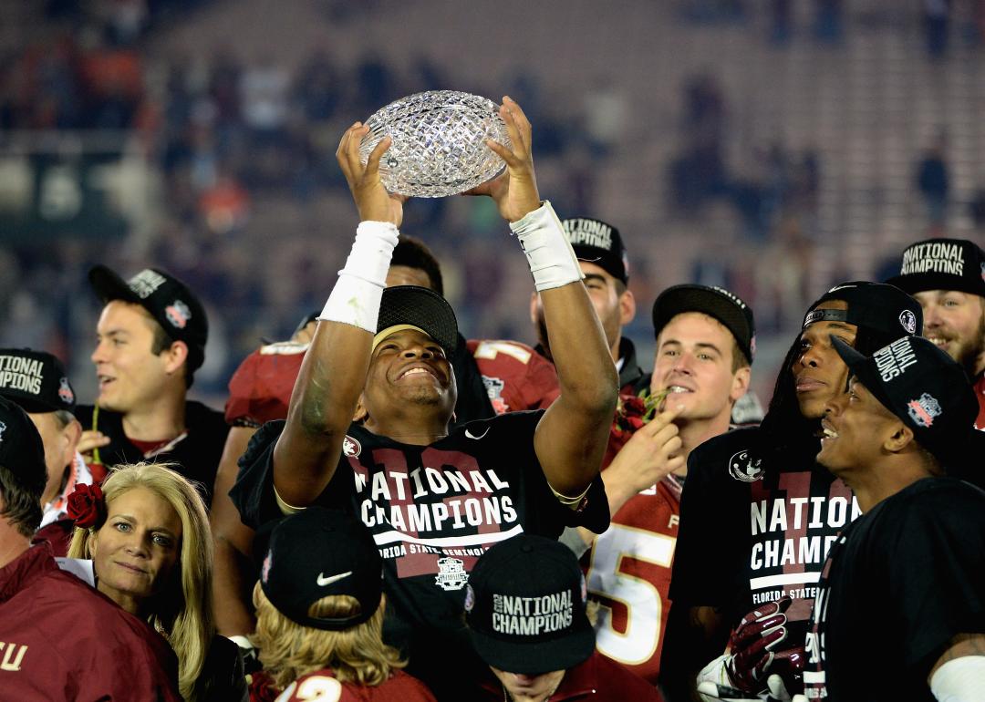 Jameis Winston of the Florida State Seminoles holds the trophy after defeating Auburn in the 2014 National Championship Game.