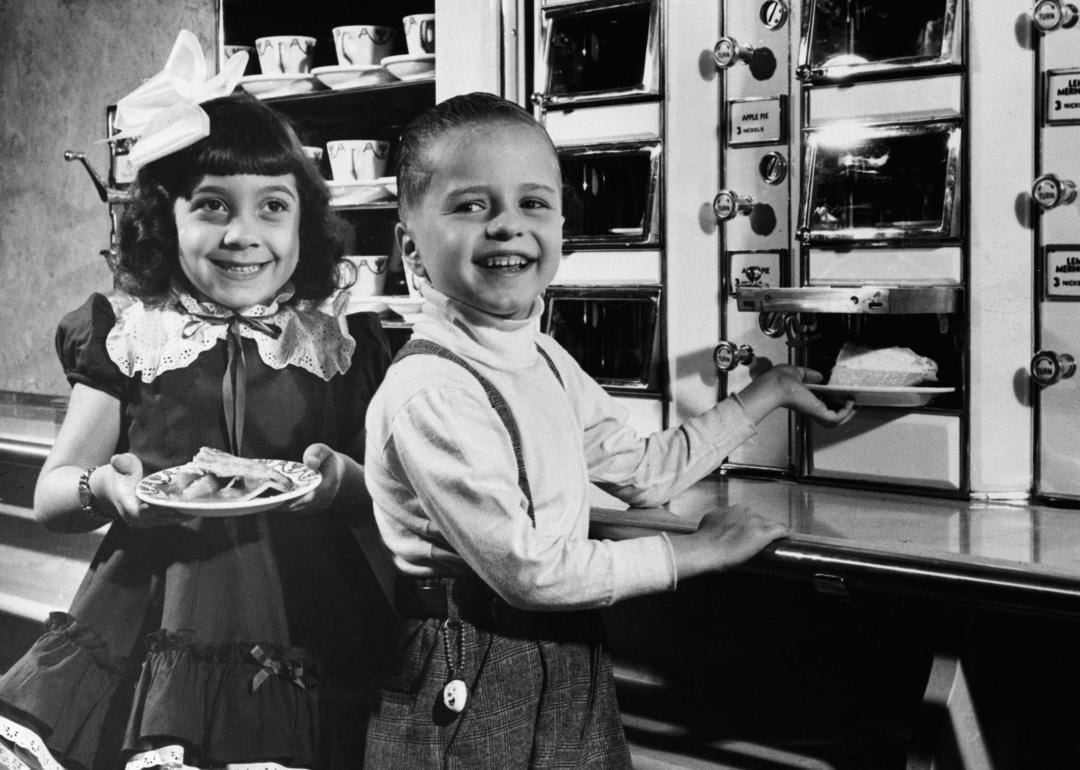 Children selecting pieces of pie from automat.