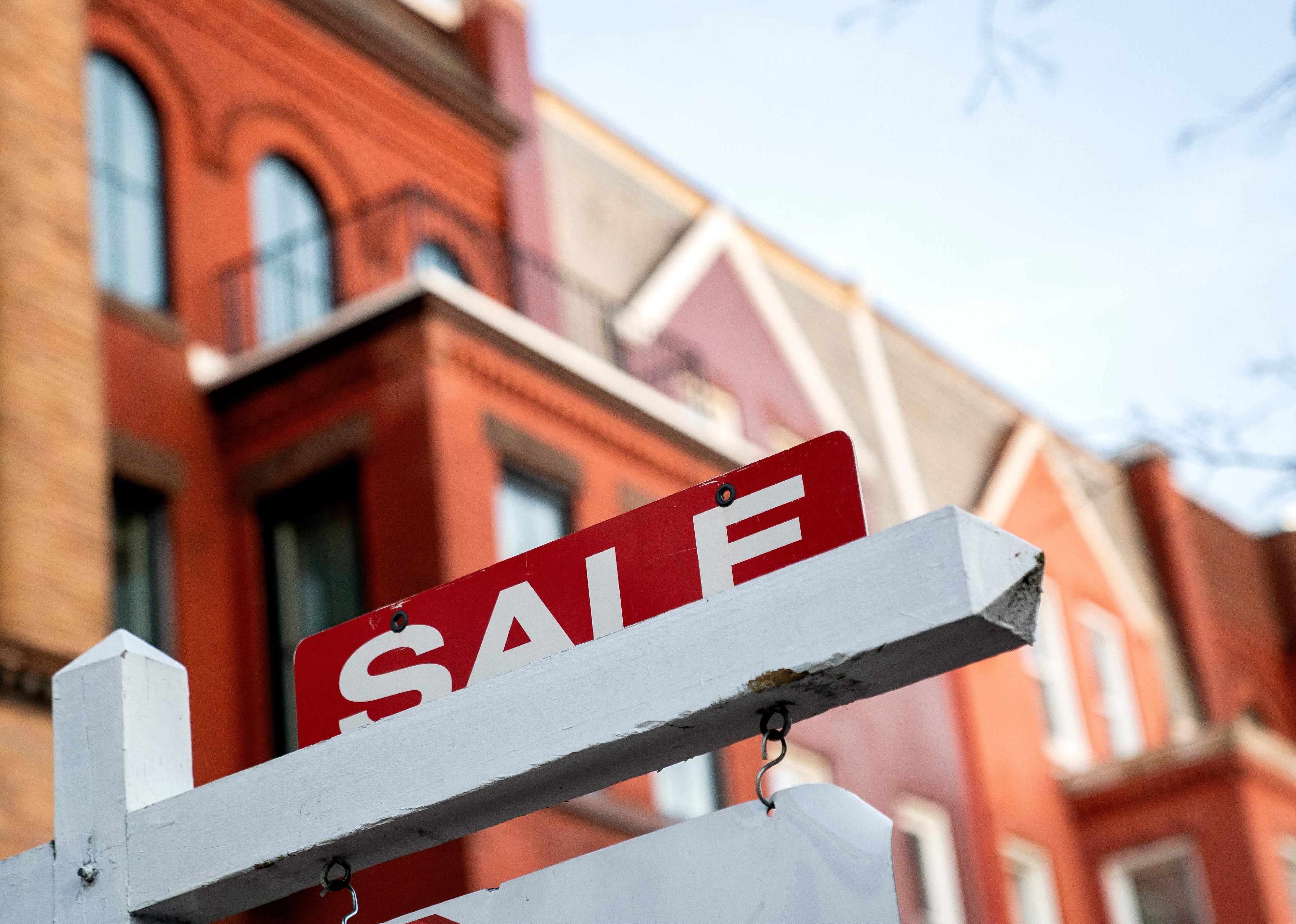 A For Sale sign is displayed in front of a house in Washington D.C.