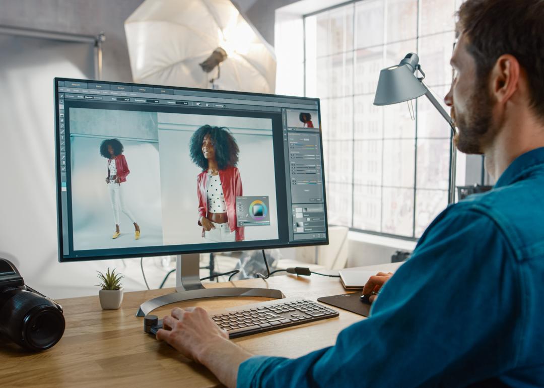 Photographer at desk editing photos.