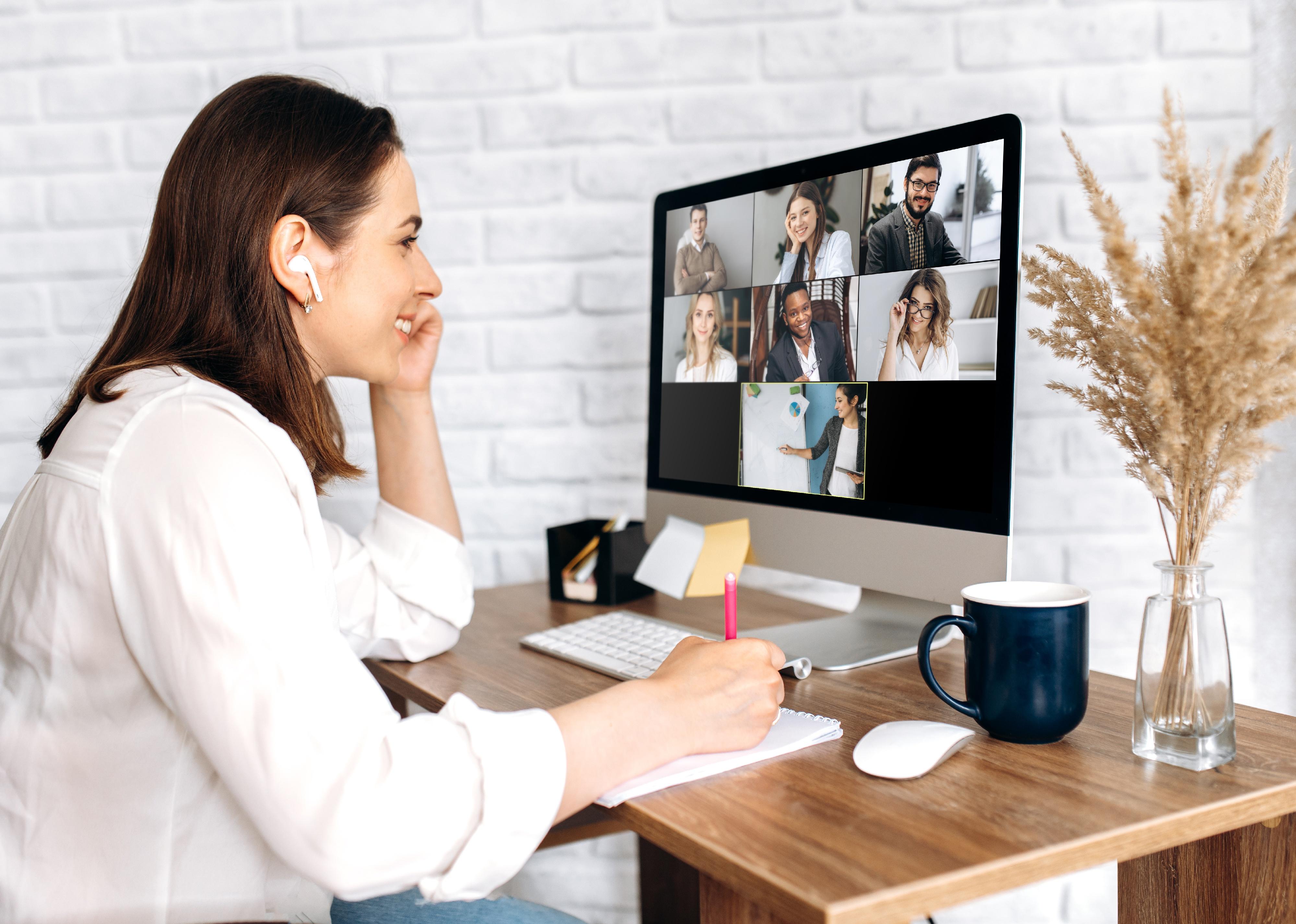 A female on a video call with coworkers