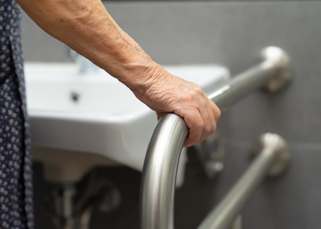 A person uses a bar in a bathroom.