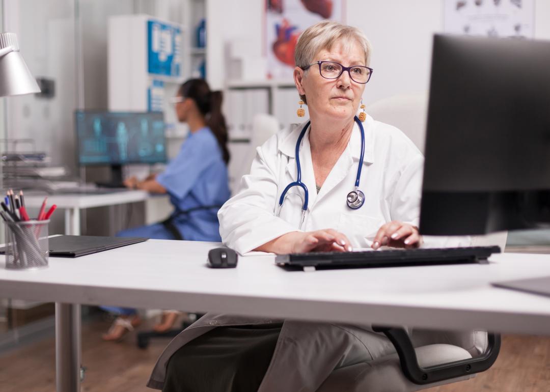 Doctor using computer in clinic.