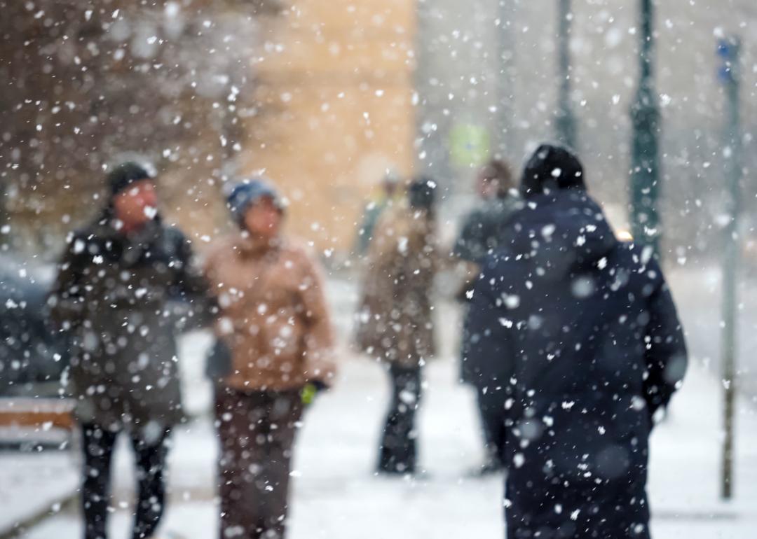 Pedestrians in a city during a severe blizzard.
