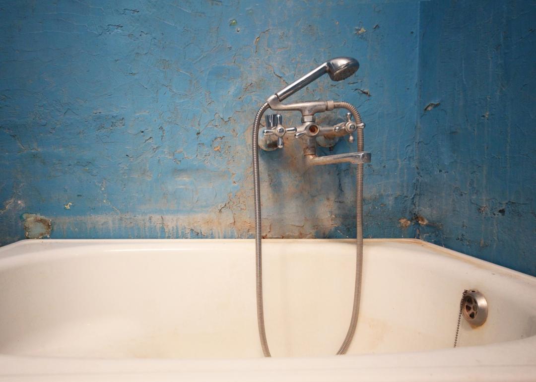 Dirty water tap in broken bathroom