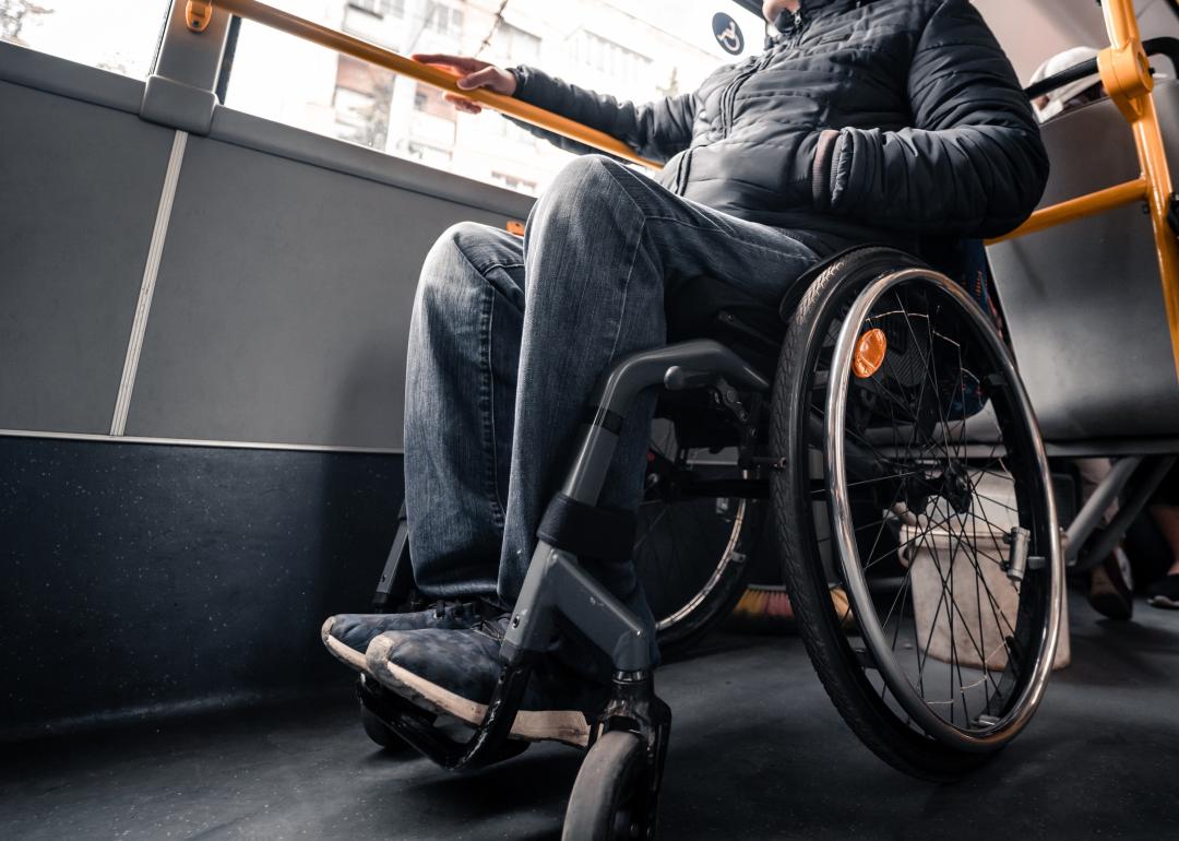 Person in a wheelchair on public transport with an accessible ramp.