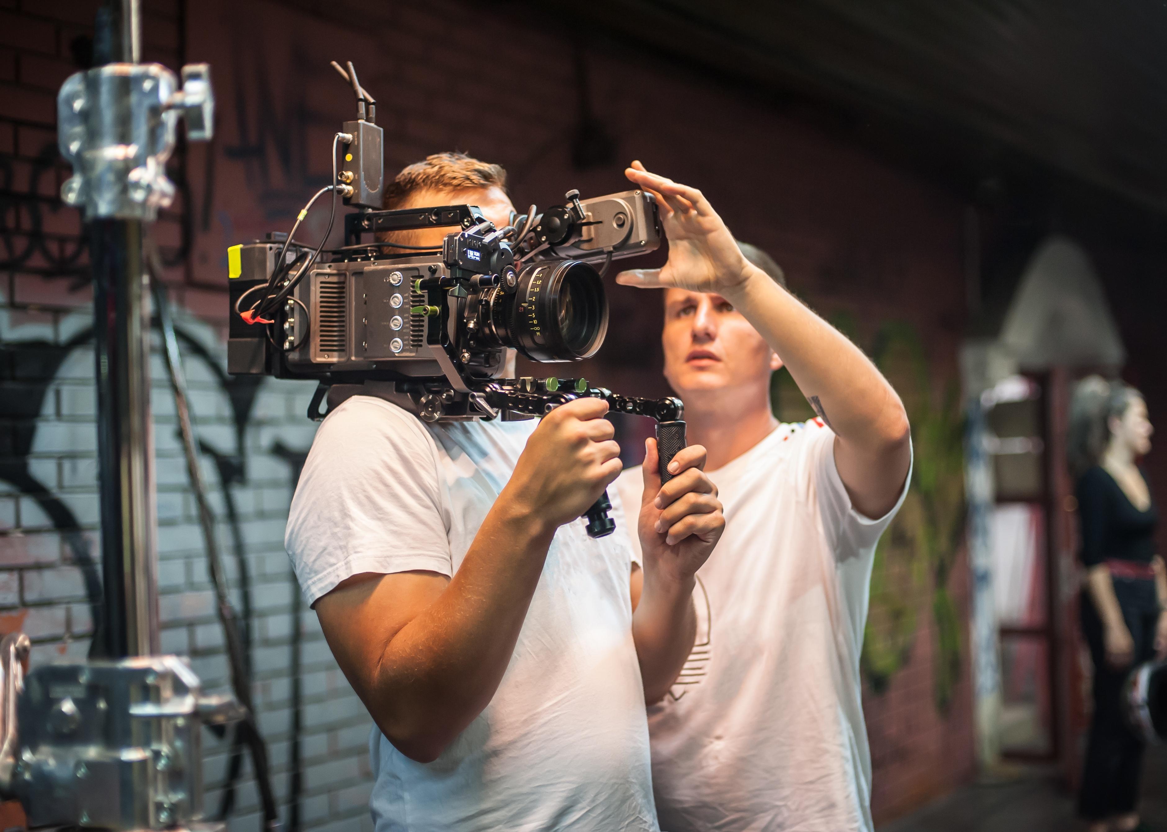 Two cameramen shooting a scene on outdoor set