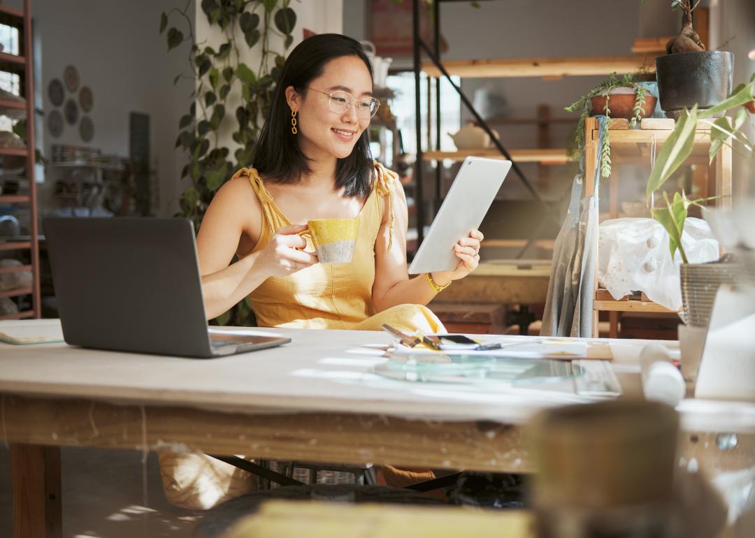 Business owner with coffee and ipad.