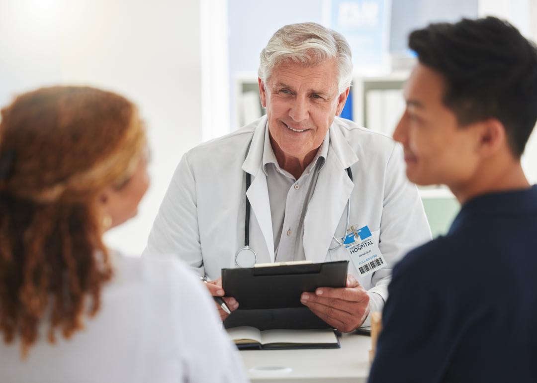 Doctor meeting a with a couple.