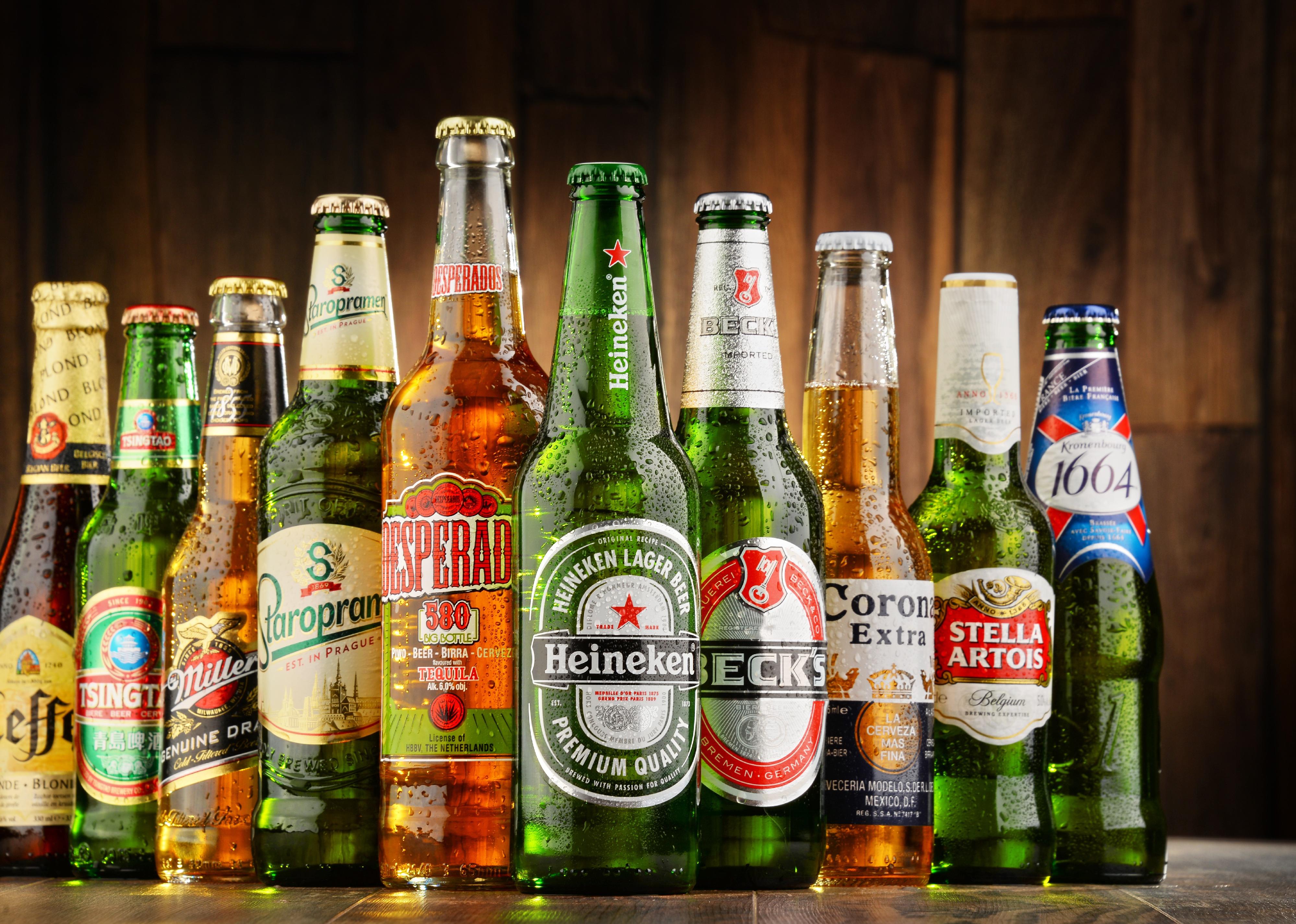 Multiple brands of beer bottles lined up