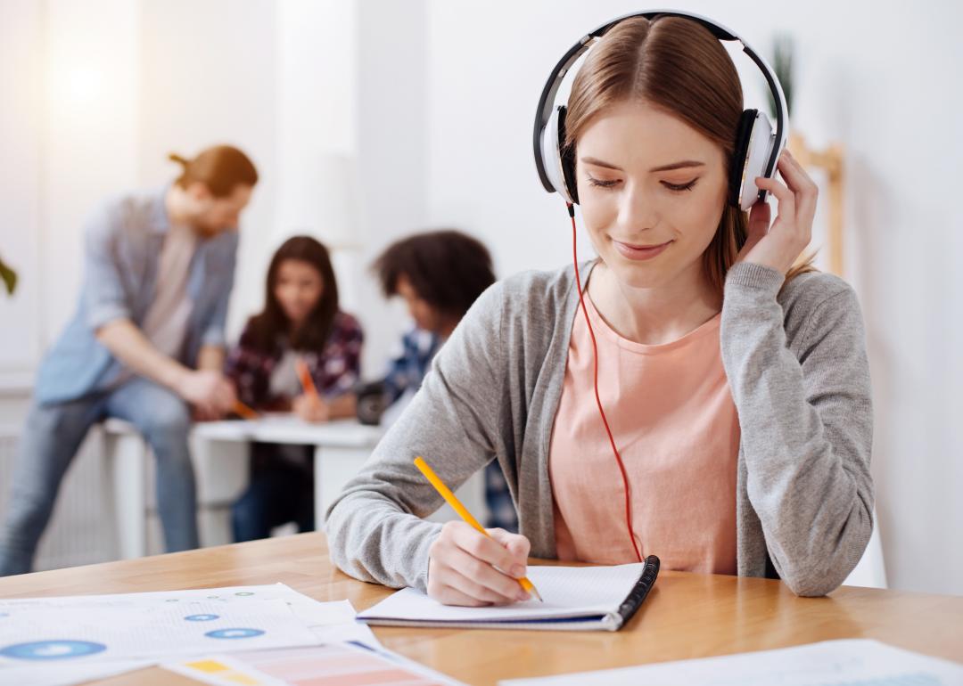 Young student writing a transcript.