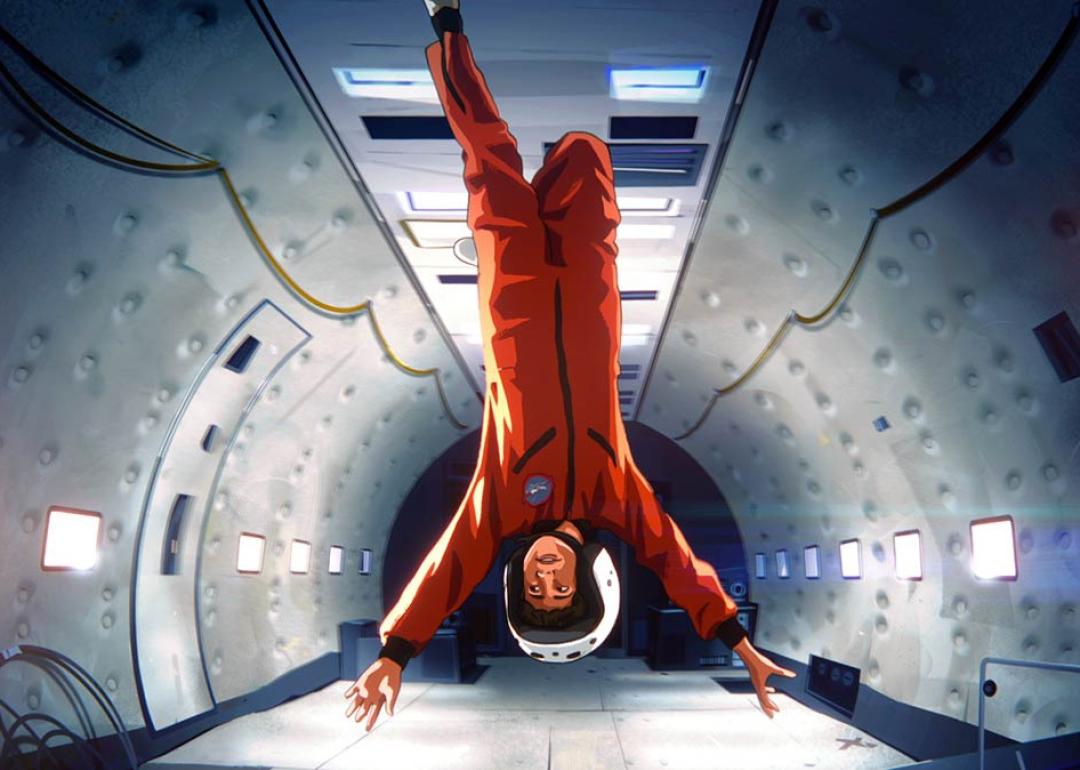 Boy astronaut floating upside down in spacecraft