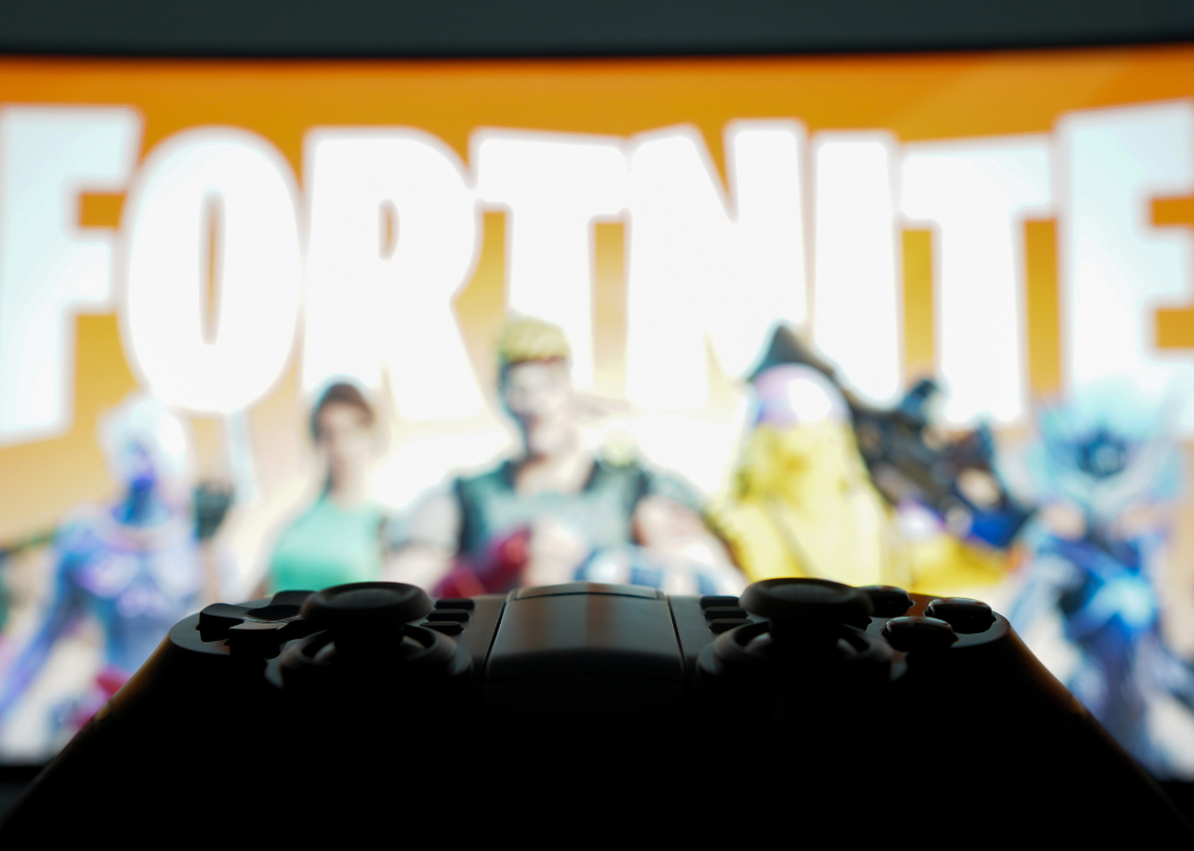 A game controller and Fortnite in the background.
