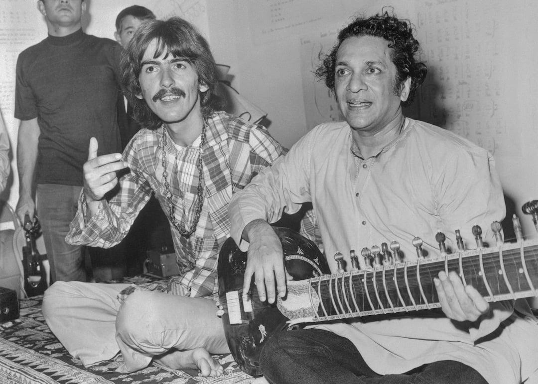 Beatle George Harrison listens as Ravi Shanker plays the sitar in 1967.