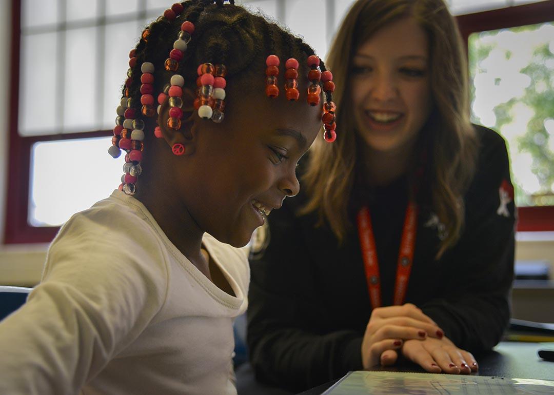 Americorps reading tutor Kelly Meany, L, gives one-on-one reading instructions to 7-year-old 2nd grader Madissen Moody at C.W. Harris Elementary School in D.C where Corps members play a huge role in DC public schools, teaching kids to read and acting as role models, on Friday, September 19, 2014