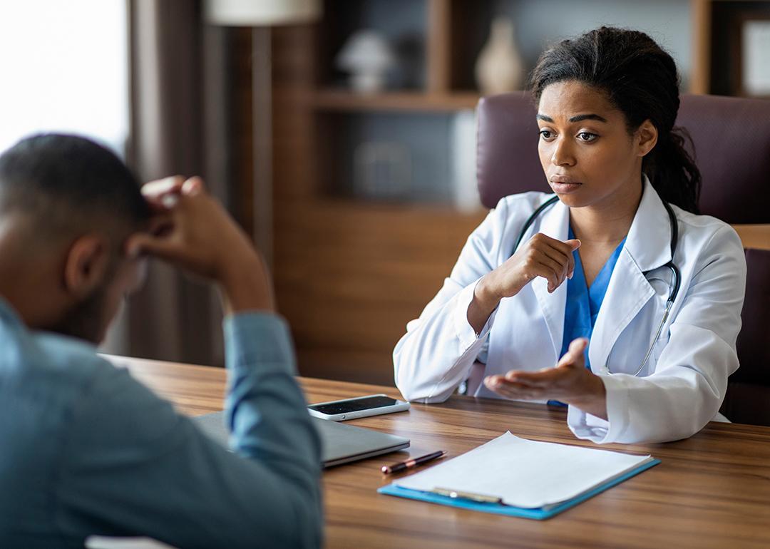 Black female doctor having a conversation with her patient.