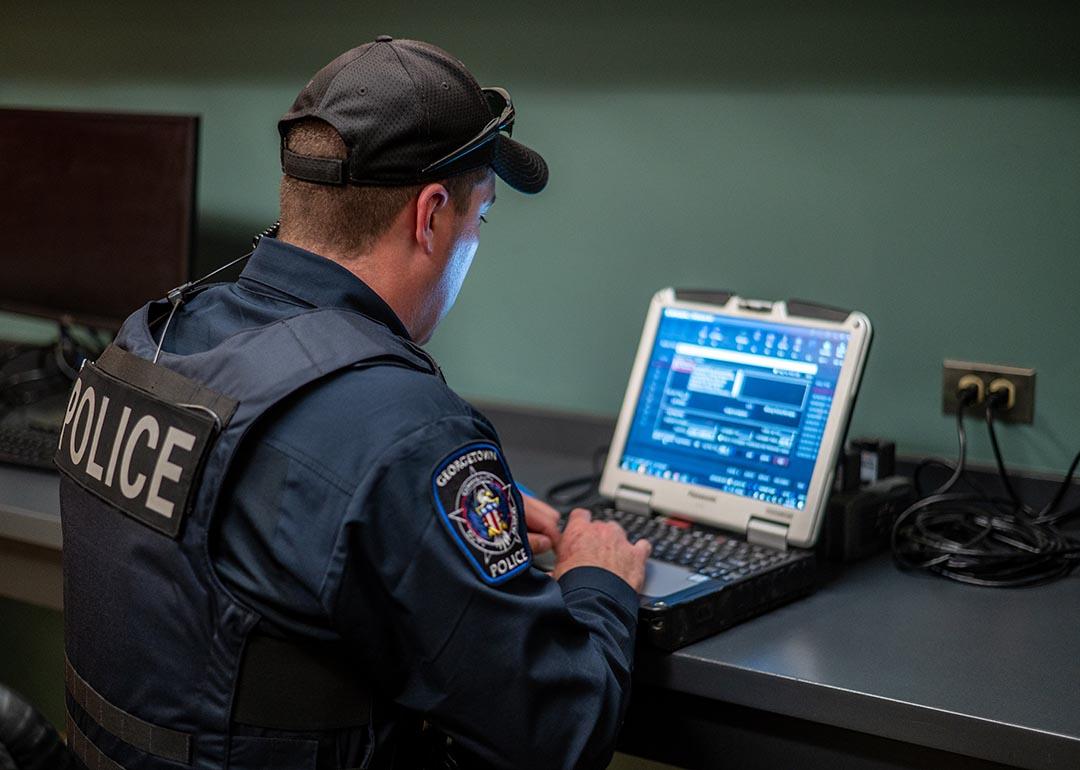 A police officer uses his computer in Georgetown, Texas, in 2023.