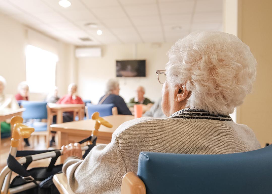 Elderly woman in a nursing home activity area.