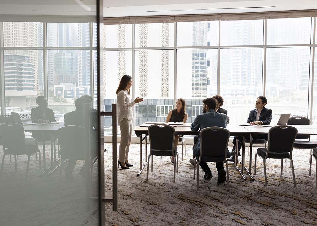 A business team engaged in a discussion in a meeting room.