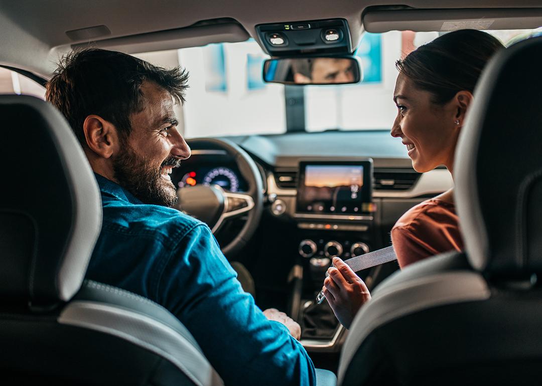 Couple inside a brand new car.