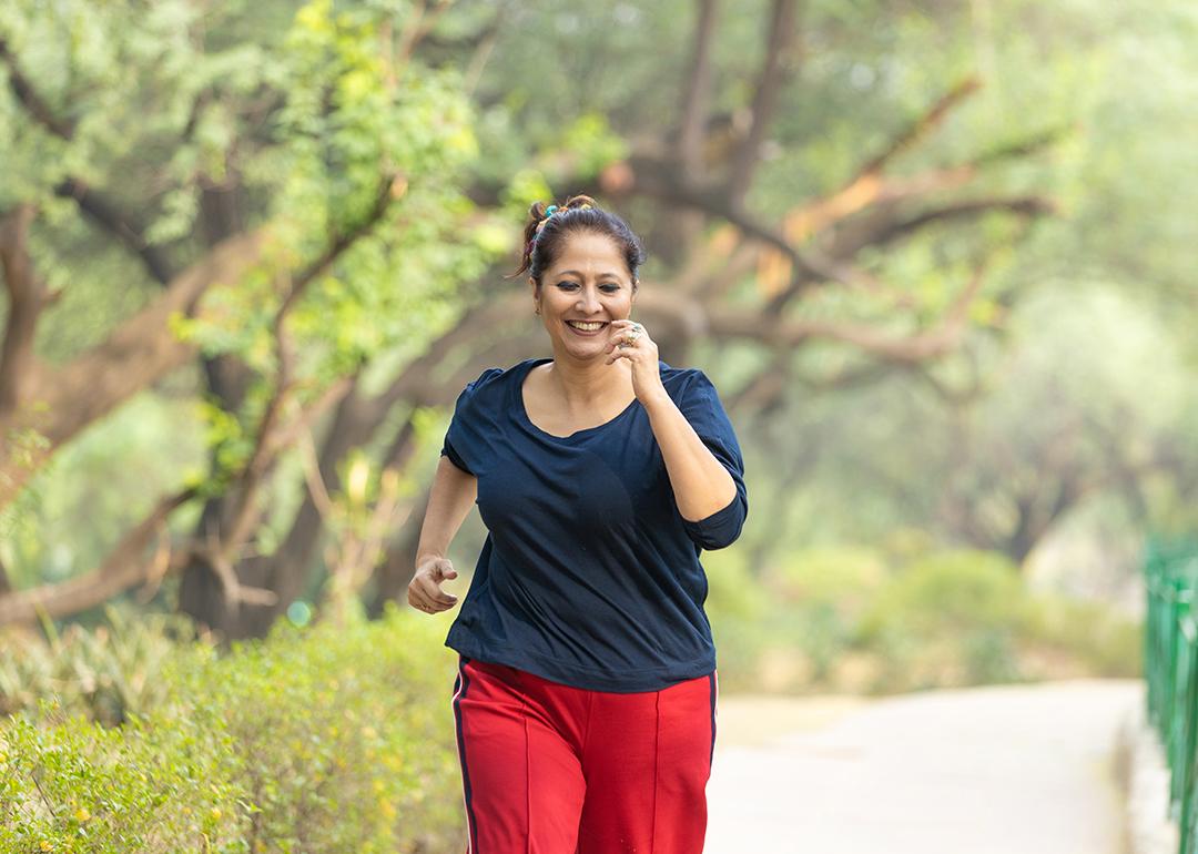 A middle-aged woman jogging at the park.