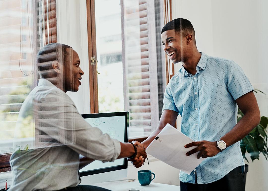 Two businessmen shaking hands after a meeting.